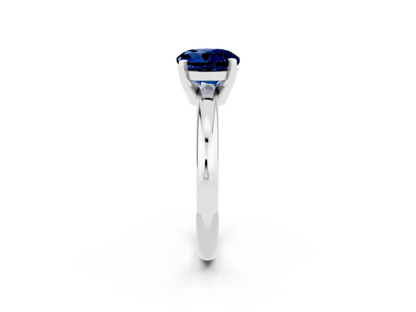 Platinum Round Cut Blue Sapphire Solitaire Engagement Ring with Round Band and Four-Prong Setting