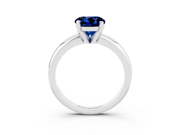 Platinum Round Cut Blue Sapphire Solitaire Engagement Ring with Round Band and Four-Prong Setting