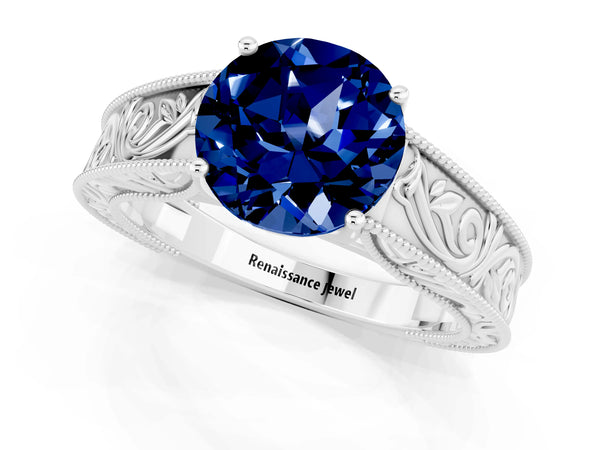 Silver Round Cut Blue Sapphire Solitaire Ring with Engraved Band and Four-Prong Setting