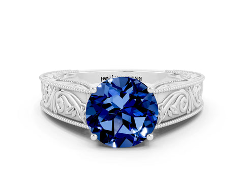 White gold Round Cut Blue Sapphire Solitaire Ring with Engraved Band and Four-Prong Setting