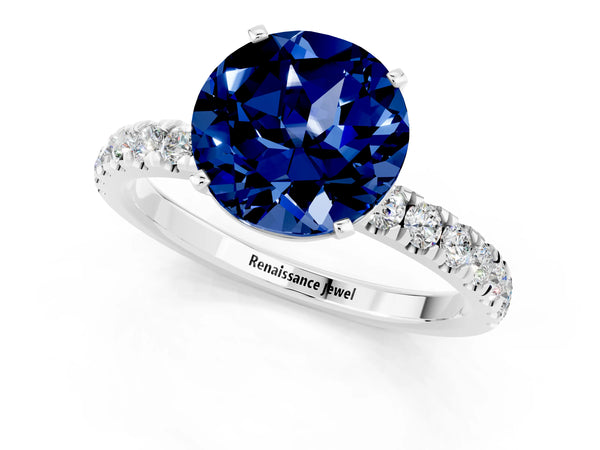 Platinum Round Cut Blue Sapphire Solitaire Ring with Pavé Accents and Four-Prong Setting