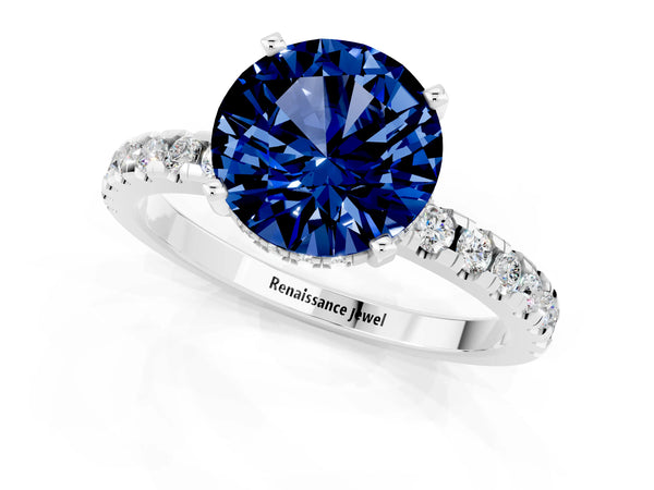 Silver Round Cut Blue Sapphire Solitaire Ring with Round  Pavé Band and Four-Prong Setting