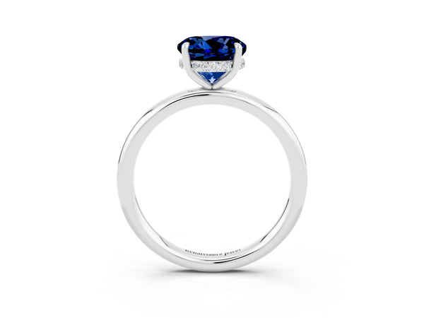 Platinum Round Cut Blue Sapphire Solitaire Ring with Thin Band and Four-Prong Setting