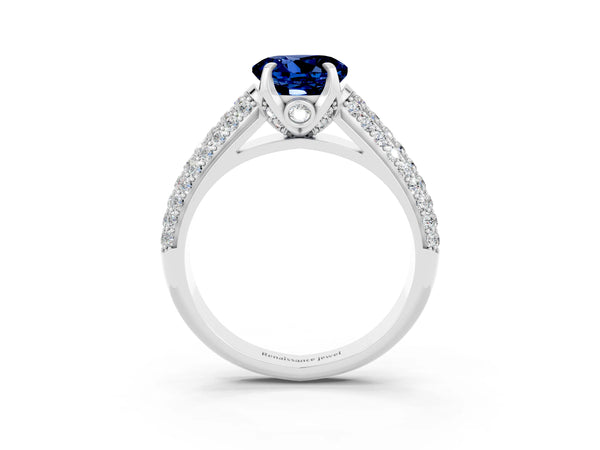 Platinum Round Cut Blue Sapphire Solitaire Ring with Three-Row Pavé Band and Four-Prong Setting