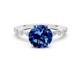White gold Round Cut Blue Sapphire Solitaire with Side Stones on a Pavé Band and Four-Prong Setting