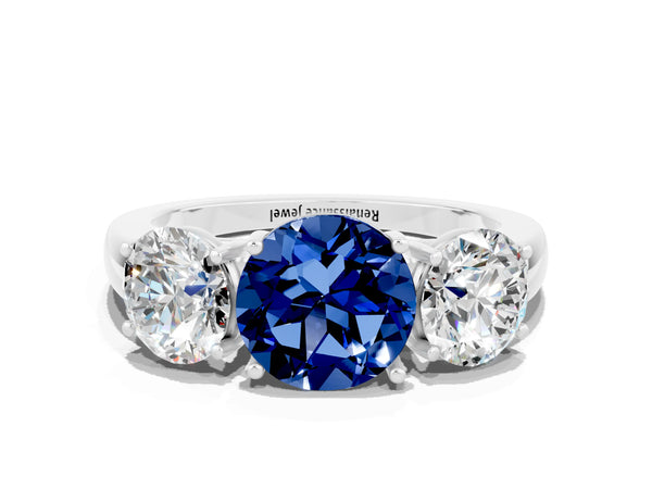 Platinum Round Cut Blue Sapphire Three-Stone Ring with Four-Prong Setting and Classic Band