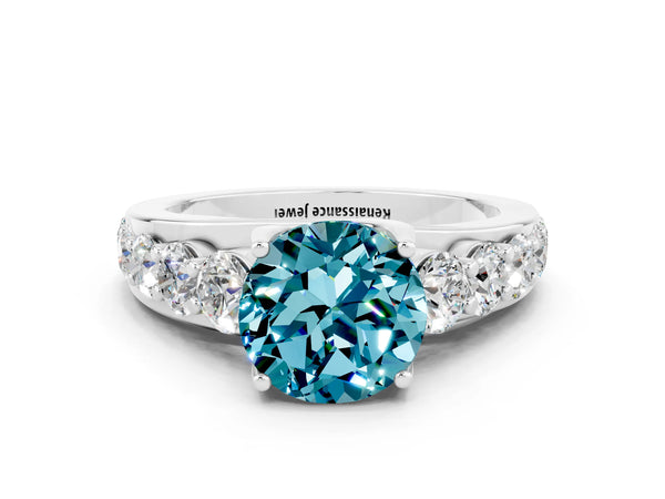 Silver Round Cut Blue Topaz Engagement Ring with Pavé Band and Four-Prong Setting
