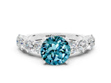 White gold Round Cut Blue Topaz Prong Setting with Side Stones on a Pave Band