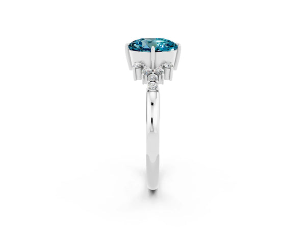 Silver Round Cut Blue Topaz Ring with Side Stones and Four-Prong Setting
