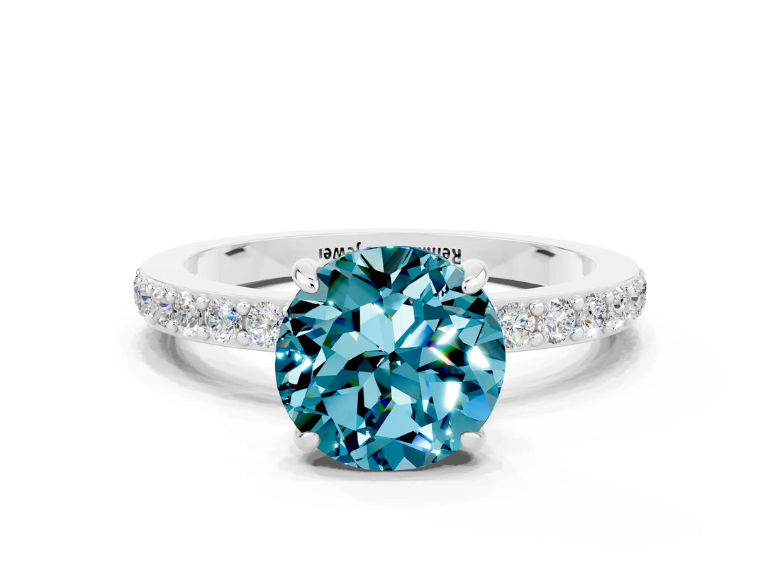 White gold Round Cut Blue Topaz Solitaire Engagement Ring with Pavé Band and Four-Prong Setting