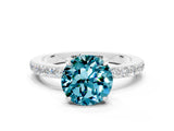 White gold Round Cut Blue Topaz Solitaire Engagement Ring with Pavé Band and Four-Prong Setting