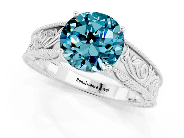 Silver Round Cut Blue Topaz Solitaire Ring with Engraved Band and Four-Prong Setting