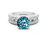 White gold Round Cut Blue Topaz Solitaire Ring with Pavé and Channel Set Band