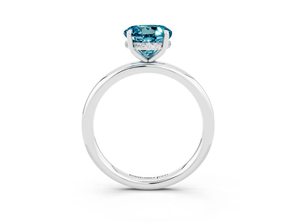 Platinum Round Cut Blue Topaz Solitaire Ring with Thin Band and Four-Prong Setting