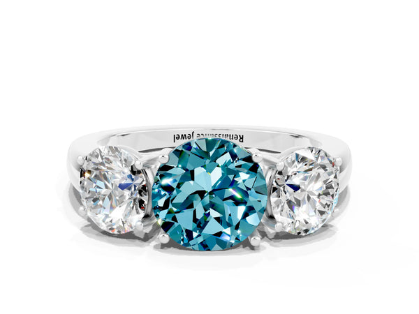 Platinum Round Cut Blue Topaz Three-Stone Ring with Four-Prong Setting and Classic Band