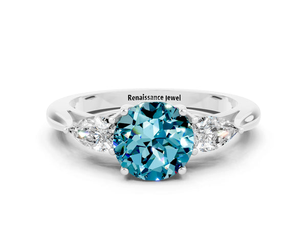 Platinum Round Cut Blue Topaz Three-Stone Ring with Pear  Side Stones and Prong Setting