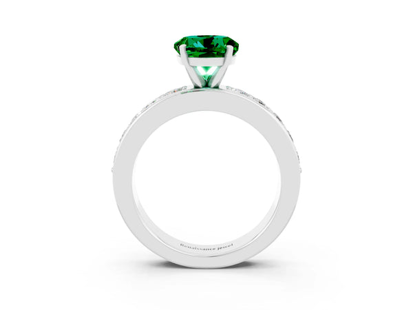 Platinum Round Cut Emerald Engagement Ring with Channel Set Round Band and Prong Setting