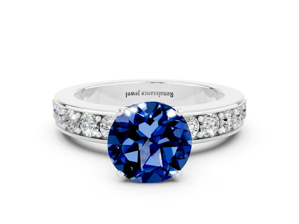 Silver Round Cut Blue Sapphire Engagement Ring with Channel Set Round Band and Prong Setting