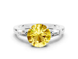 White gold Round Cut Cut Diamond Ring with Tapered Baguette Side Stones in Four-Prong Setting