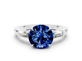 White gold Round Cut Cut Diamond Ring with Tapered Baguette Side Stones in Four-Prong Setting