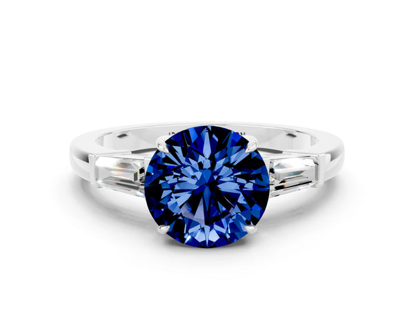 Platinum Round Cut Blue Sapphire Three-Stone Ring with Tapered Baguette Side Stones and Prong Setting