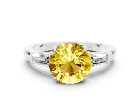 White gold Round Cut Cut Diamond Ring with Tapered Baguette Side Stones in Four-Prong Setting
