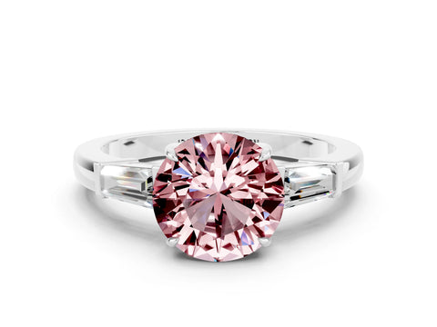 White gold Round Cut Cut Diamond Ring with Tapered Baguette Side Stones in Four-Prong Setting