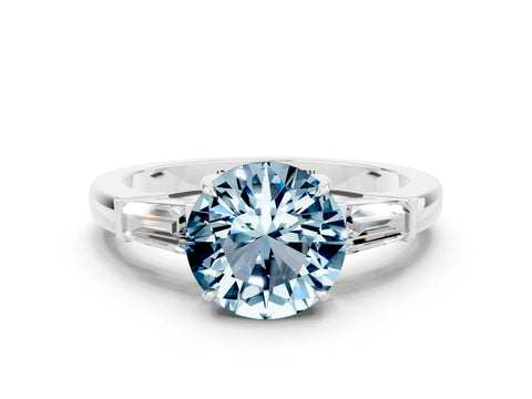 White gold Round Cut Cut Diamond Ring with Tapered Baguette Side Stones in Four-Prong Setting