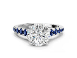 White gold Round Cut Diamond Cathedral Solitaire Ring with Round with Blue Sapphire side stone Pavé Band