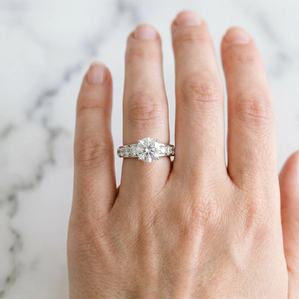 White gold Round Cut Diamond Engagement Ring with Pavé Band and Four-Prong Setting