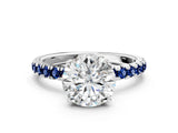 White gold Round Cut Diamond Pave Band Solitaire Ring with Round with Blue Sapphire side stone and Prong Setting