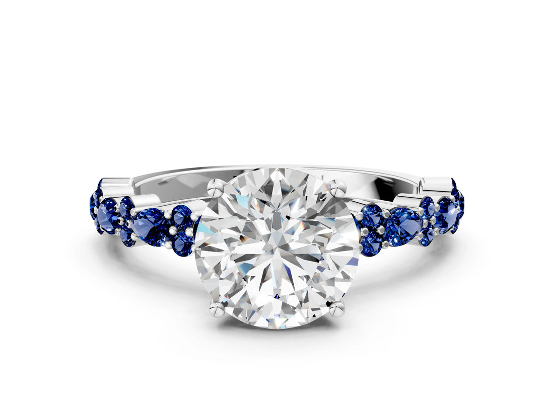 White gold Round Cut Diamond Side Stone Solitaire Ring with Round with Blue Sapphire side stone and Four-Prong Setting