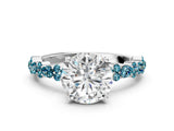 White gold Round Cut Diamond Side Stone Solitaire Ring with Round with Blue Topaz side stone and Four-Prong Setting