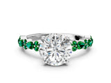 White gold Round Cut Diamond Side Stone Solitaire Ring with Round with Emerald side stone and Four-Prong Setting