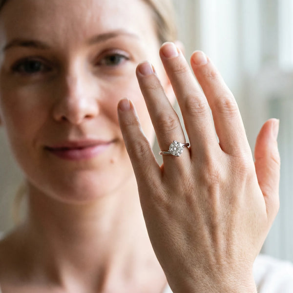 White gold Round Cut Diamond Solitaire Engagement Ring with Four-Prong Setting and Classic Band