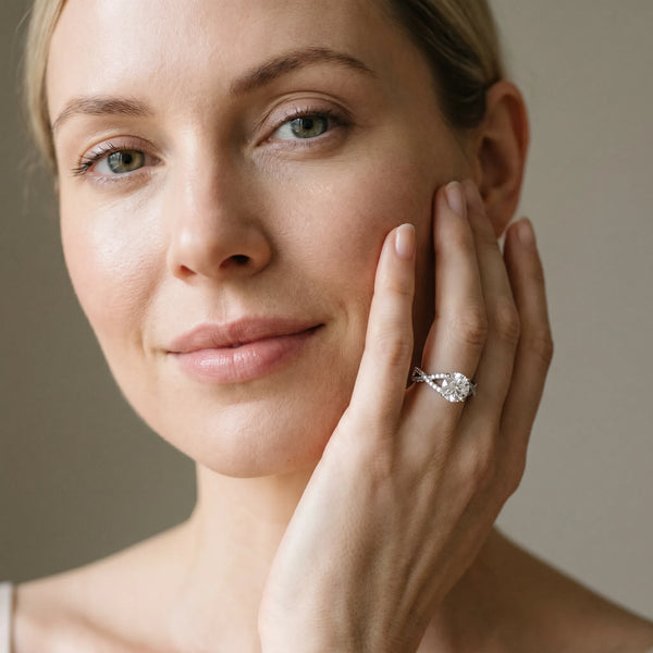 White gold Round Cut Diamond Solitaire Ring with Four-Prong Setting and Twisted Pavé Band