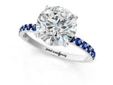 White gold Round Cut Diamond Solitaire Ring with Round with Blue Sapphire side stone Pavé Band and Prong Setting_1