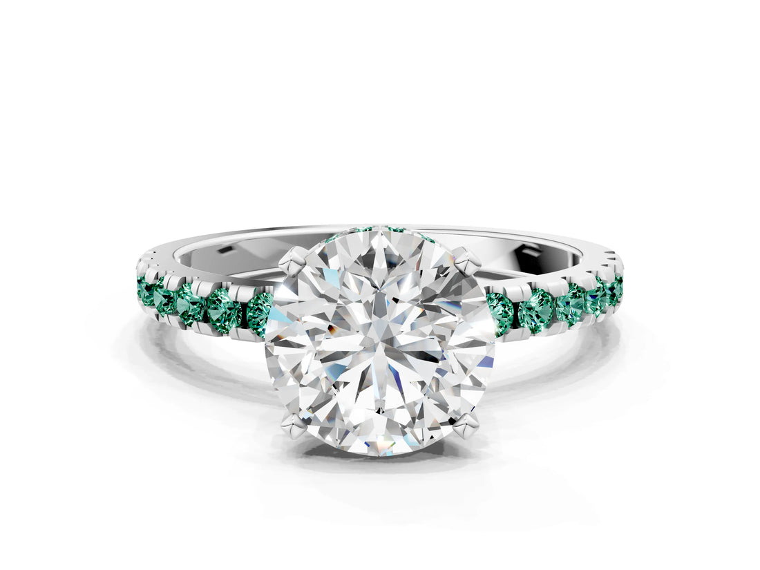 White gold Round Cut Diamond Solitaire Ring with Round with Green Sapphire side stone Pavé Band and Four-Prong Setting