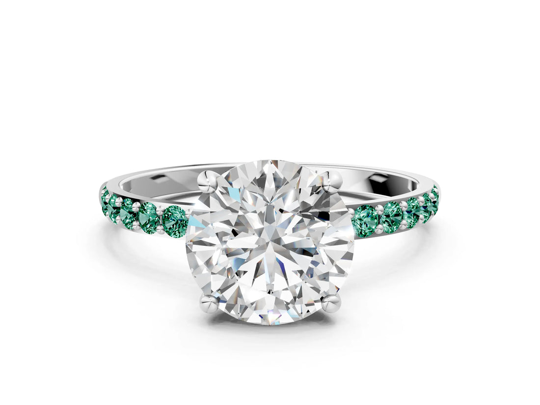 White gold Round Cut Diamond Solitaire Ring with Round with Green Sapphire side stone Pavé Band and Prong Setting