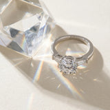 White gold Round Cut Diamond Solitaire Ring with Tapered Baguette Accents and Four-Prong Setting_107