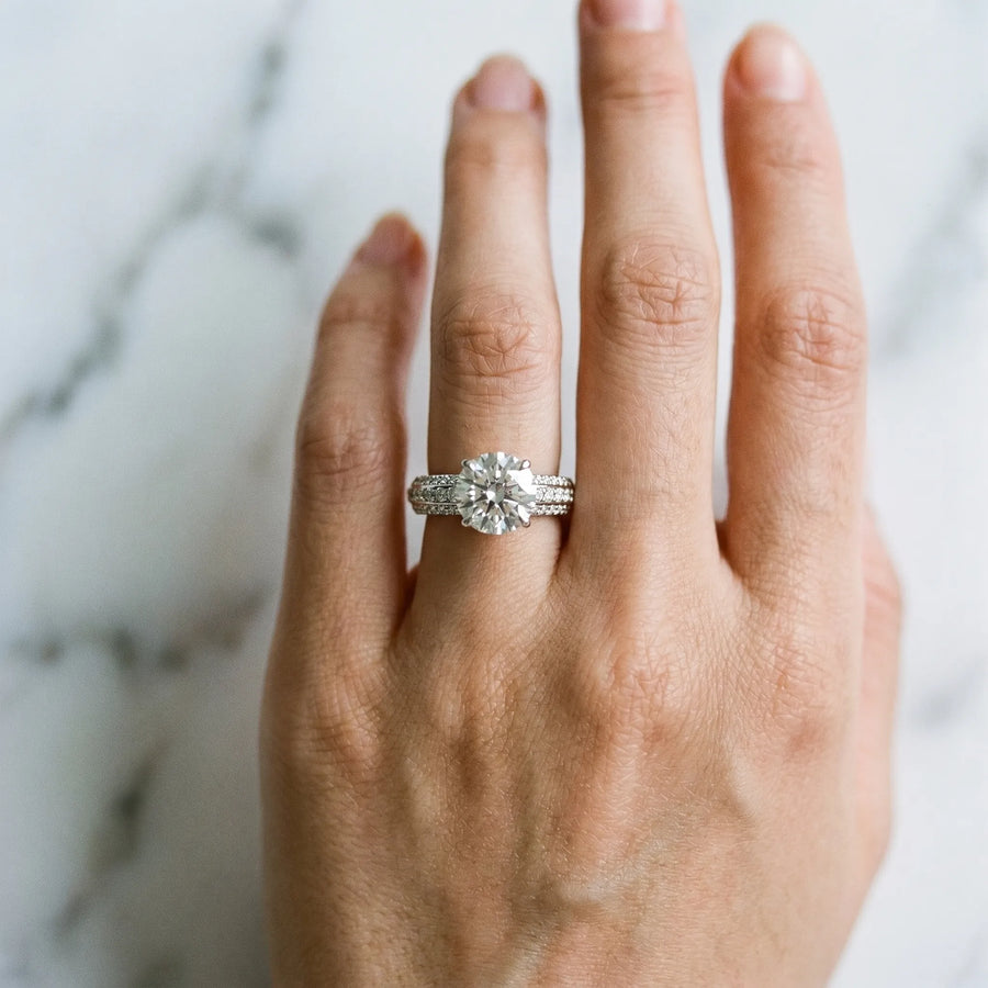 White gold Round Cut Diamond Solitaire Ring with Three-Row Pavé Band and Four-Prong Setting