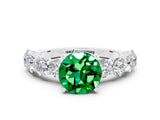 White gold Round Cut Emerald Prong Setting with Side Stones on a Pave Band