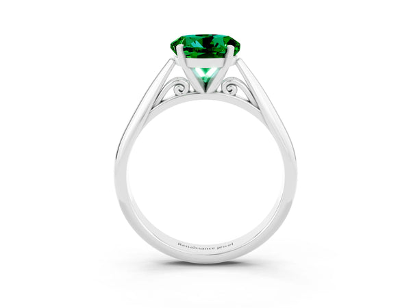 Platinum Round Cut Emerald Solitaire Engagement Ring with Cathedral Setting and Four-Prong Mount