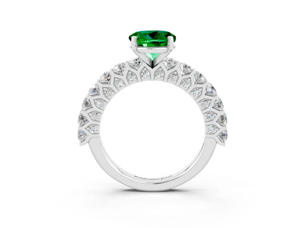 Platinum Round Cut Emerald Solitaire Ring with Shared Prong Pavé Band and Four-Prong Setting