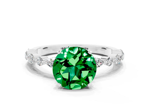 White gold Round Cut Emerald Solitaire with Side Stones on a Pavé Band and Four-Prong Setting