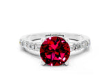 White gold Round Cut Garnet Solitaire with Side Baguettes and Channel Set Band