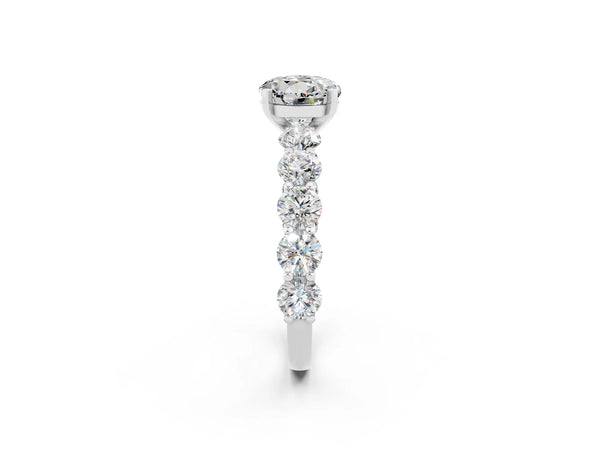 White gold Round Cut Moissanite Prong Setting with Side Stones on a Pave Band