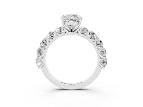 White gold Round Cut Moissanite Prong Setting with Side Stones on a Pave Band