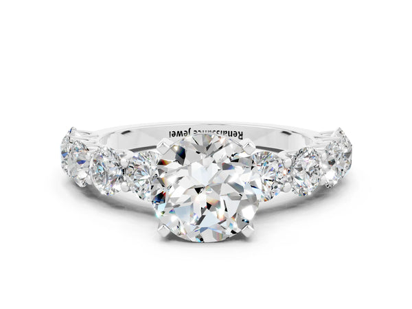 White gold Round Cut Moissanite Prong Setting with Side Stones on a Pave Band