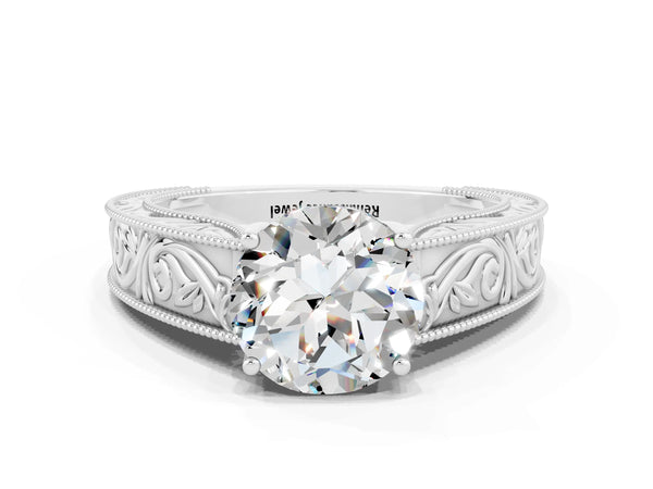 White gold Round Cut Moissanite Solitaire Ring with Engraved Band and Four-Prong Setting